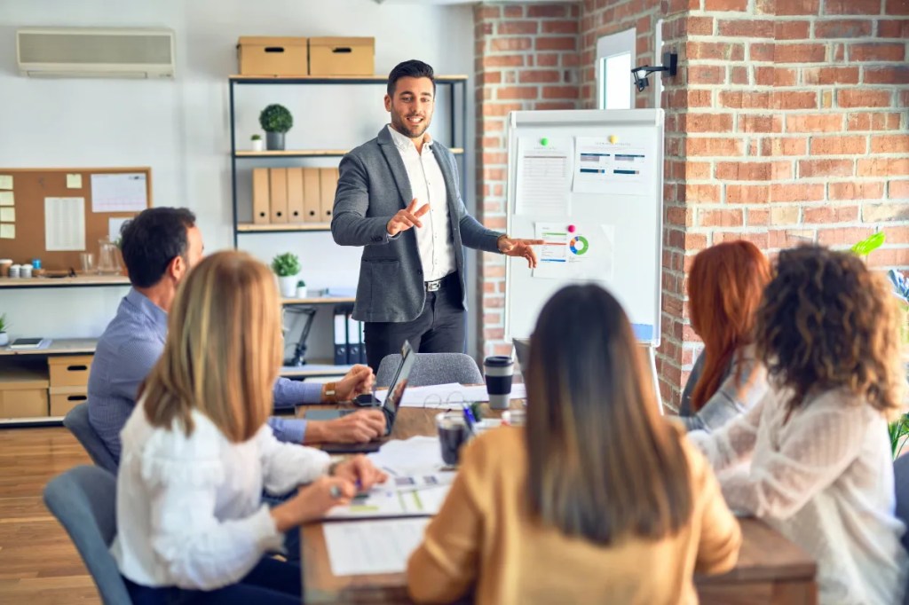 young man making a business presentation in a meeting with co-workers