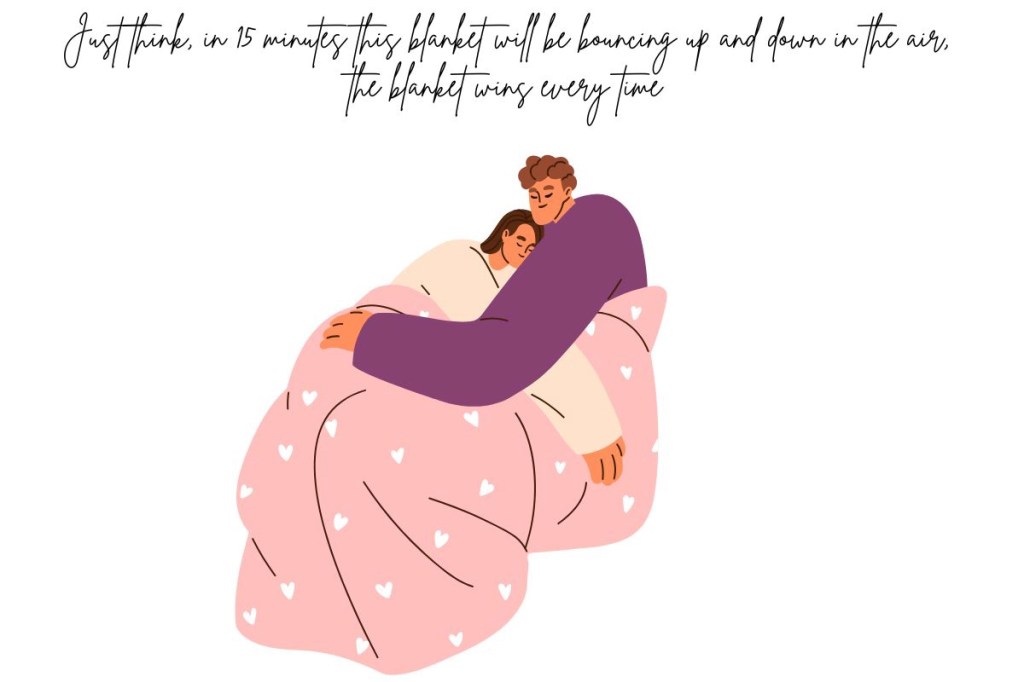 A young couple snuggling undr a blanket