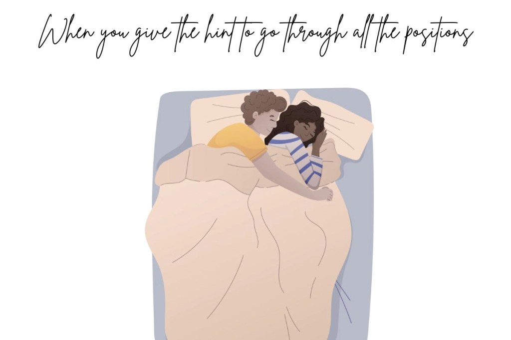 A young couple snuggling in bed from behind