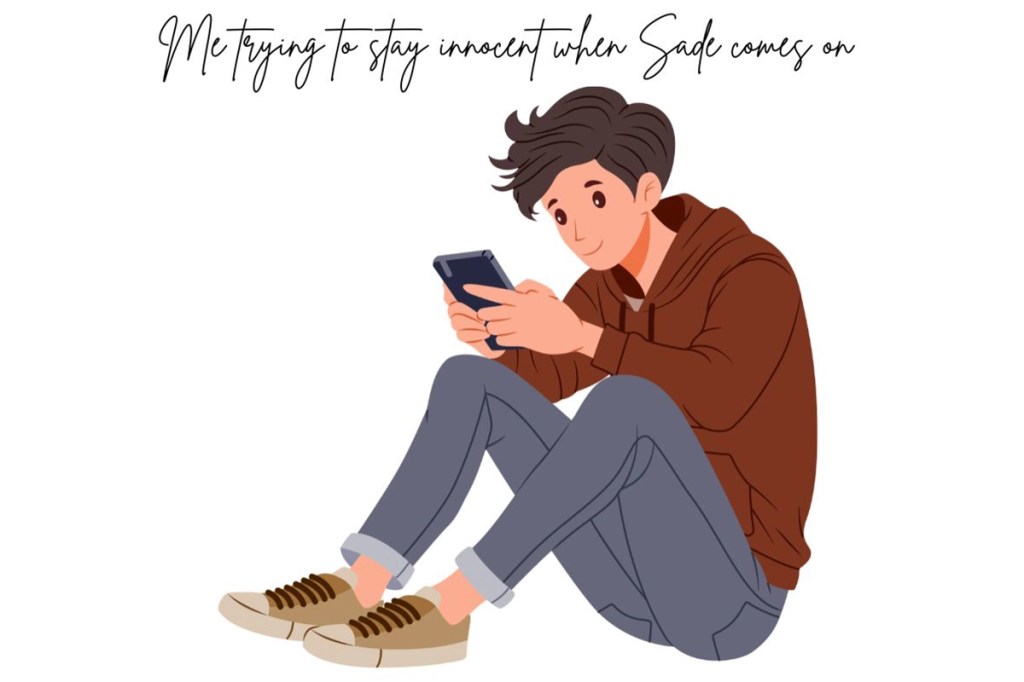 a young man texting on the phone on the ground